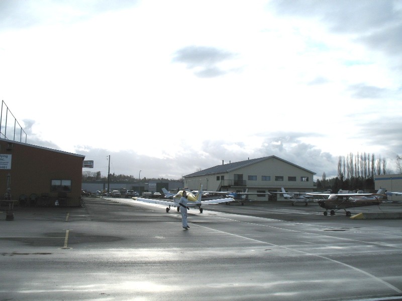 Flight Instructor Naomi Jones goes to meet Alex Cadar after Alex's First Solo Flight.  Langley Flying School.